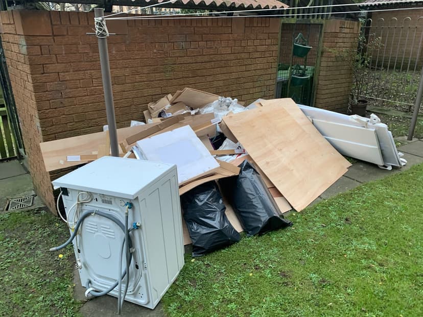 pile of household rubbish and bulky waste outside property in Brighton