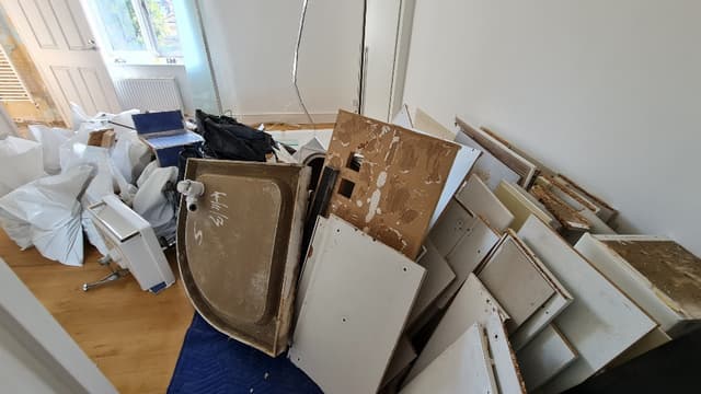 pile of household rubbish and bulky waste outside property in Camden