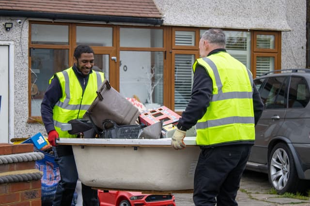 bulky waste collection London workers loading household waste into truck