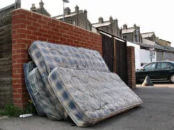 mattresses leaning on eachother outside kerbside